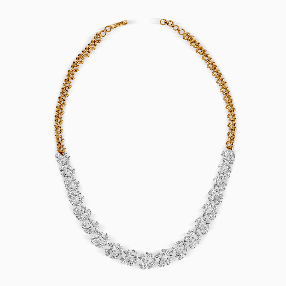 Gold and silver leaf-like necklace with intricate diamond cluster design