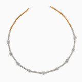 Gold and diamond tennis necklace with alternating large and small stones, elegant curved design