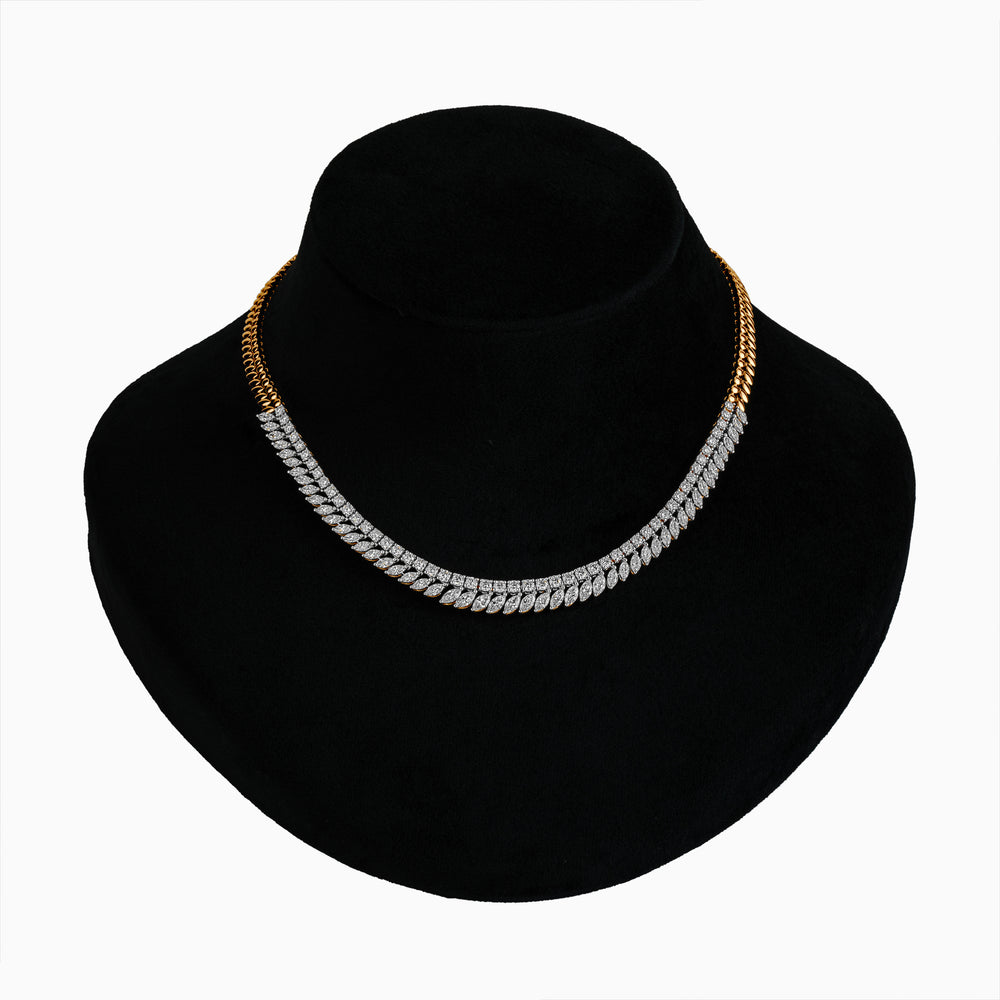 Diamond and gold two-tone chain necklace on black jewelry display bust