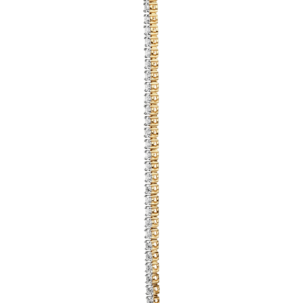 Gold and silver tennis bracelet with alternating diamond links