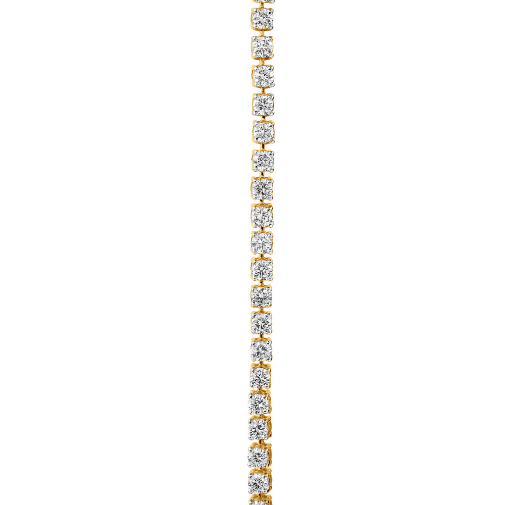 Gold tennis bracelet with alternating round diamonds in square settings