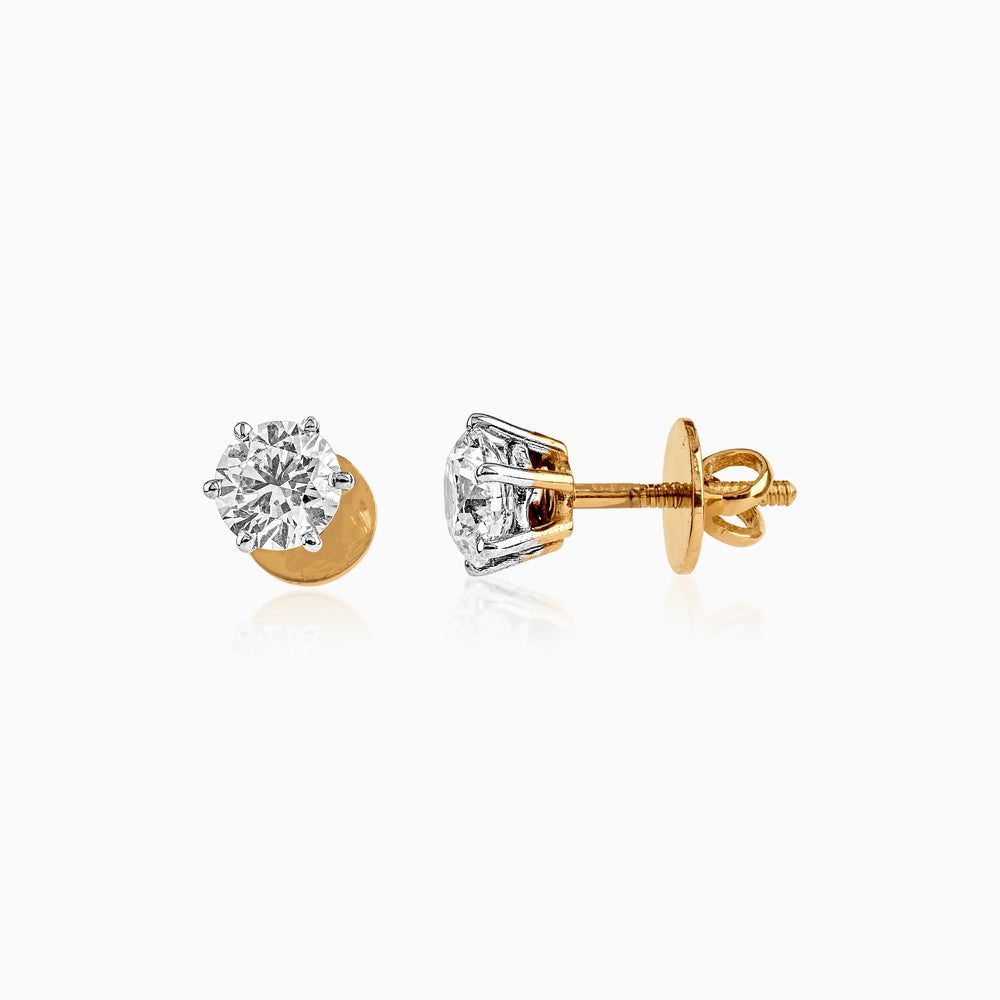 Gold and silver stud earrings with round brilliant diamond in six-prong setting