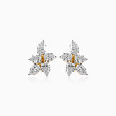 Diamond cluster earrings with gold and white gemstones in a star-like arrangement