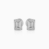 Emerald-cut diamond stud earrings in white gold, reflecting light on white background
