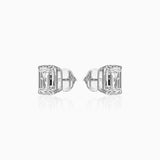 Diamond stud earrings with emerald-cut stones in white gold, reflecting light