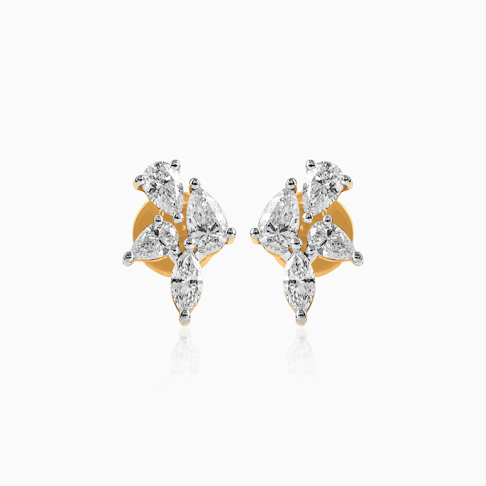 Diamond stud earrings with pear-shaped stones on gold and white metal setting