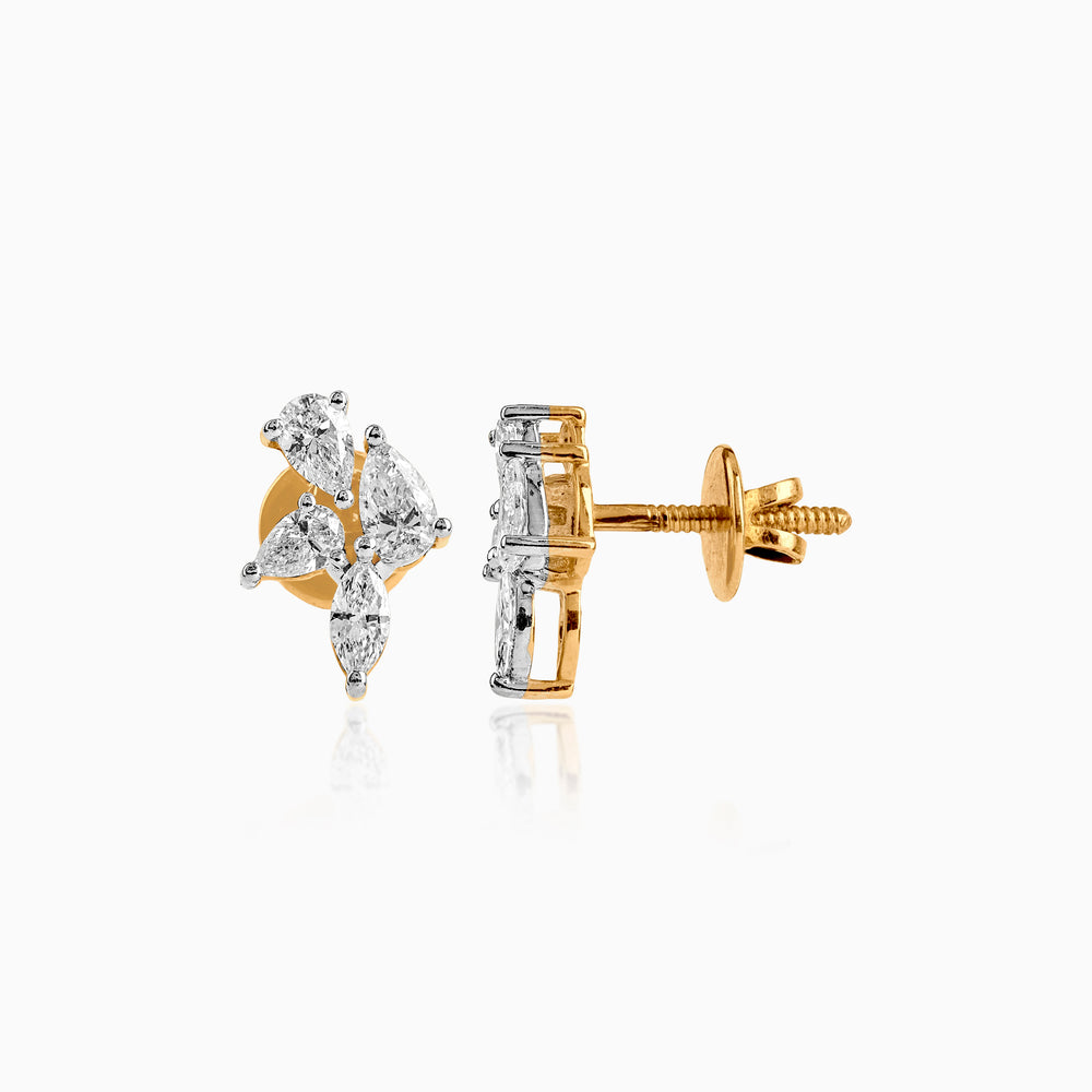 Gold and diamond stud earrings with marquise-cut stones in a delicate cluster design.