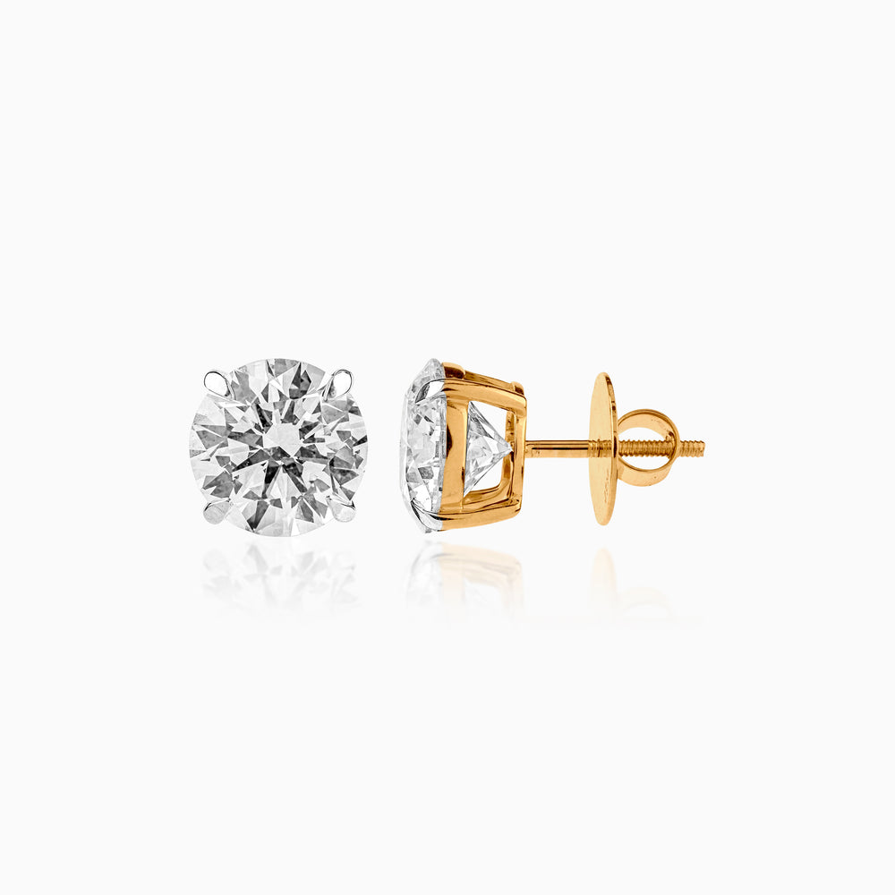 Gold and diamond stud earrings with screw-back fastening, showcasing round brilliant cut stones
