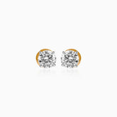 Gold-mounted round diamond stud earrings on white background
