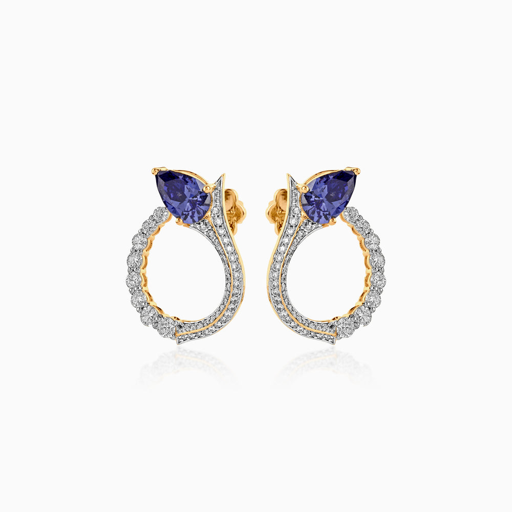 Gold hoop earrings with blue sapphire stones and diamond-encrusted band