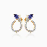 Gold and diamond earrings with blue sapphire trillion-cut stones in elegant curved design