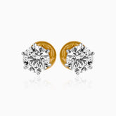 Pair of round diamond stud earrings with gold backs and silver prong settings
