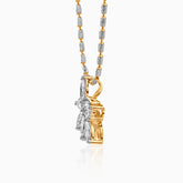 Two-tone gold and silver pendant necklace with textured chain and ornate hanging charm