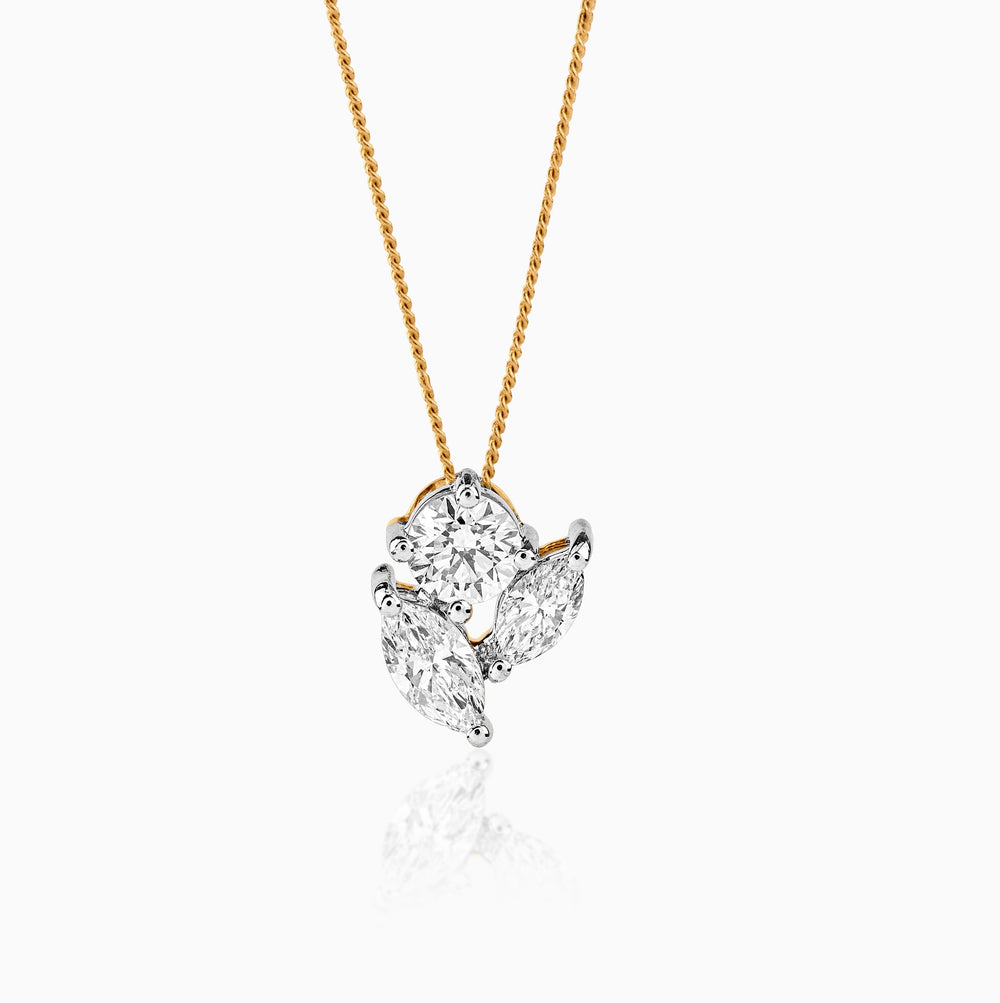 Gold chain with clustered diamond pendant, white and round cut diamonds arranged artfully.