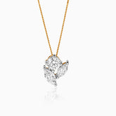 Gold chain with clustered diamond pendant, white and round cut diamonds arranged artfully.