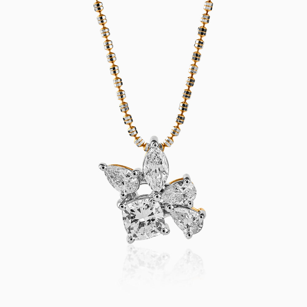 Diamond cluster pendant with mixed-cut stones on two-tone gold chain