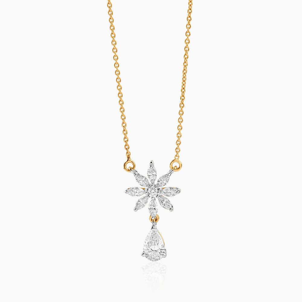 Gold chain with diamond snowflake pendant and teardrop diamond charm