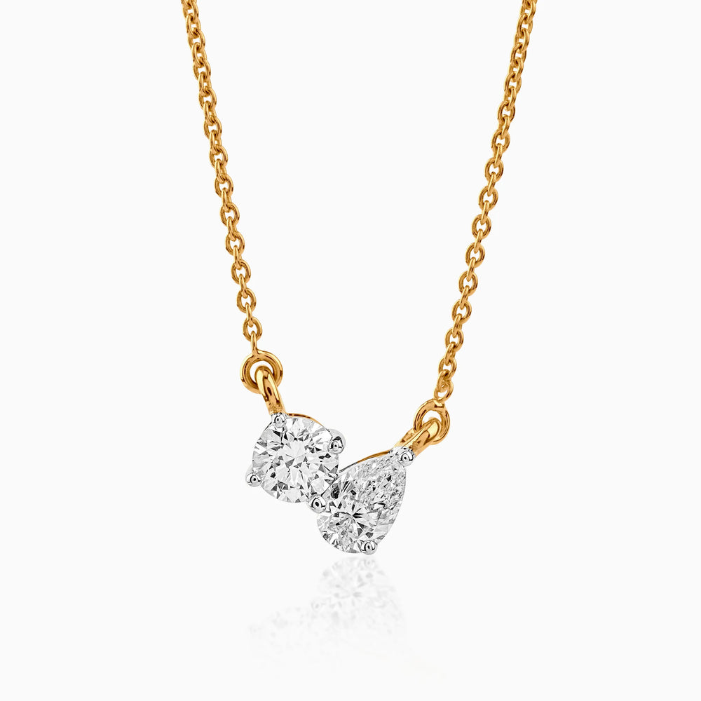 Gold chain necklace with two round and pear-shaped diamonds in white gold setting