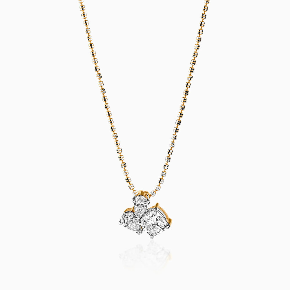 Gold and diamond pendant necklace with multi-stone cluster design on delicate chain