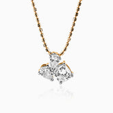 Gold chain with multi-cut diamond pendant in delicate cluster setting, gleaming against white background