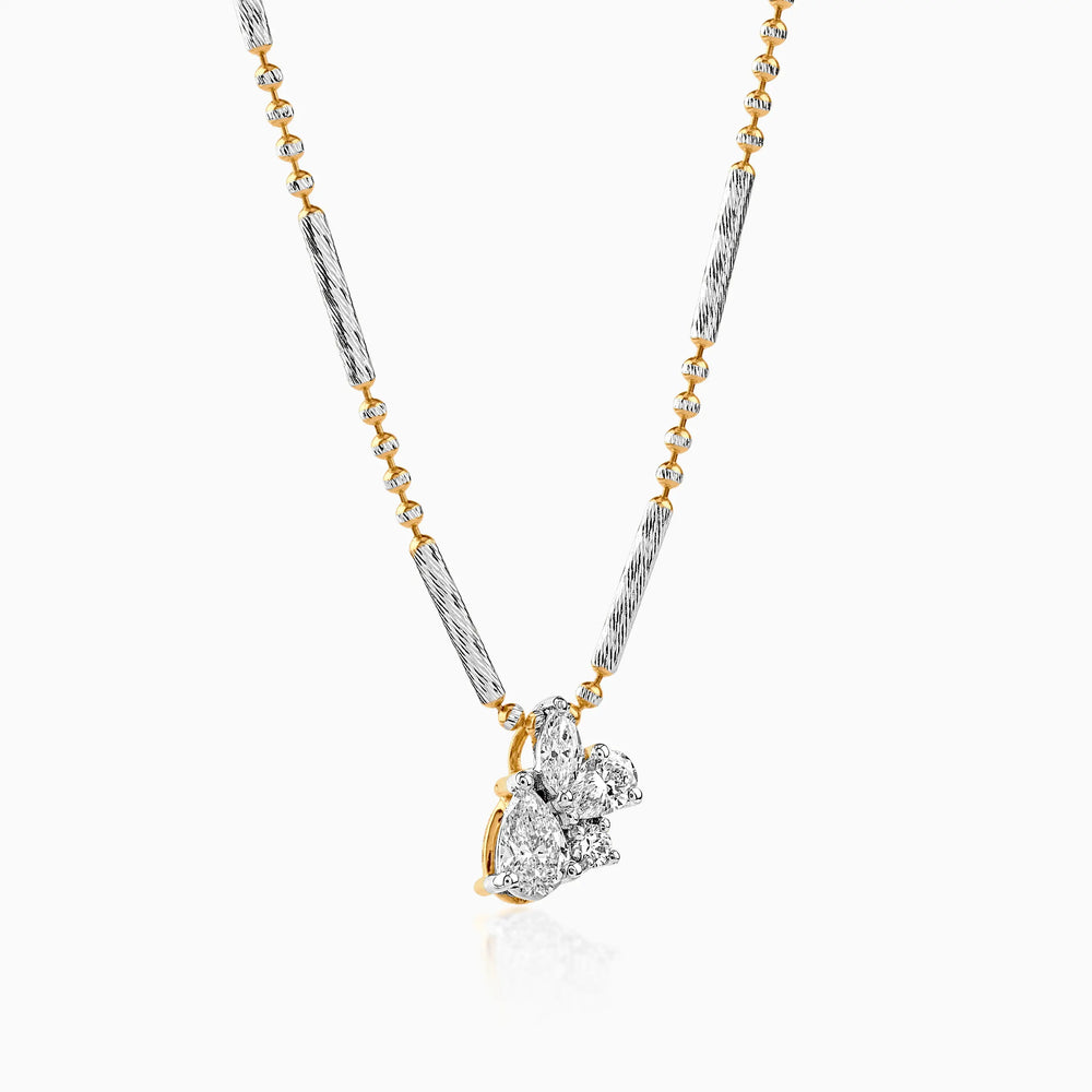 Gold and silver necklace with diamond cluster pendant, delicate two-tone chain design.
