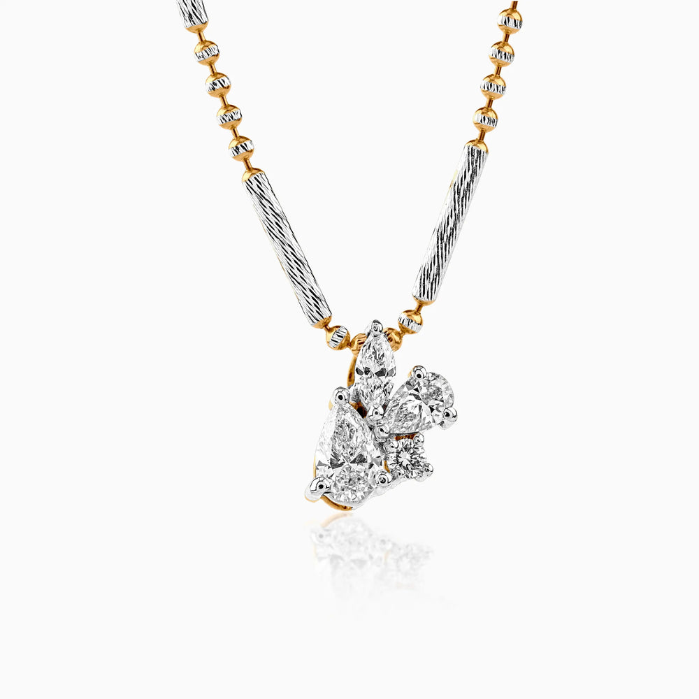 Gold and silver necklace with clustered diamond pendant on textured chain