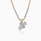Gold and silver necklace with clustered diamond pendant on textured chain