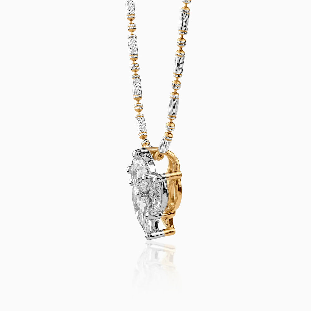 Two-tone gold and silver pendant necklace with ornate chain and large gemstone enhancer