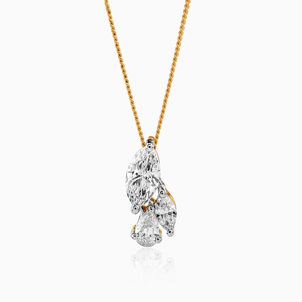 Gold chain with three-stone pear-cut diamond pendant on white background
