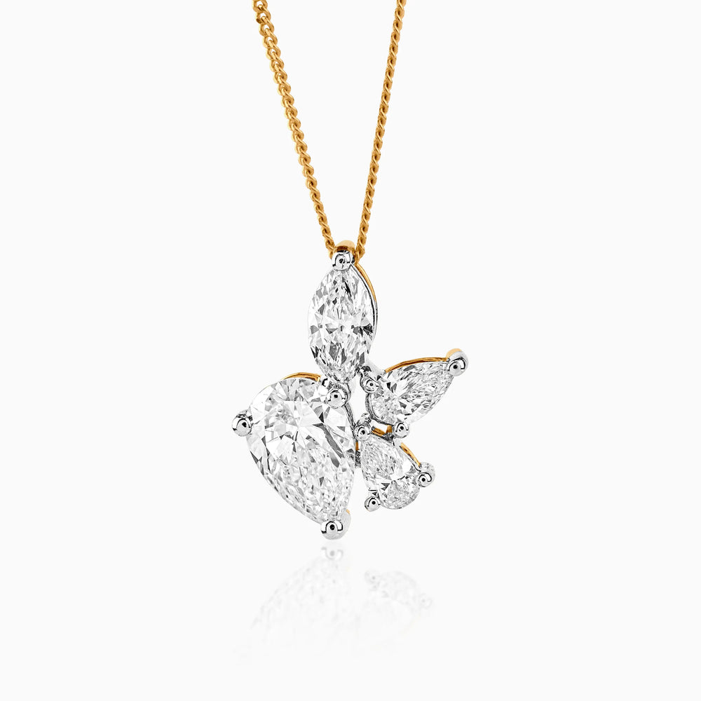 Diamond butterfly pendant on gold chain with multiple teardrop-shaped stones