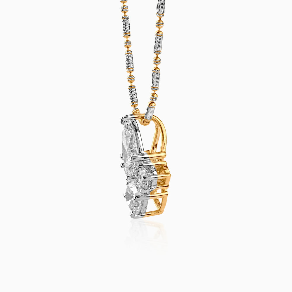 Two-tone silver and gold diamond pendant on intricate mixed metal chain