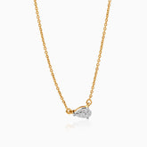 Gold chain necklace with pear-shaped diamond pendant on white background