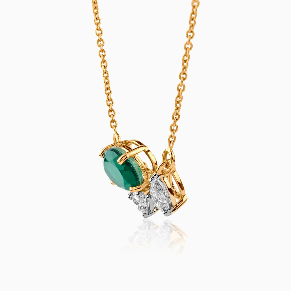 Gold necklace with emerald green stone and white diamond pendant on delicate chain