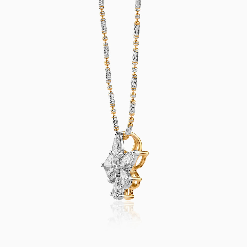Delicate two-tone diamond flower pendant on an intricate silver and gold chain