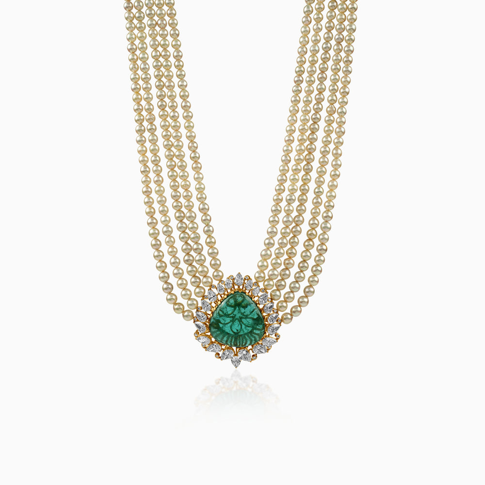 Multi-strand pearl necklace with emerald pendant surrounded by diamond halo