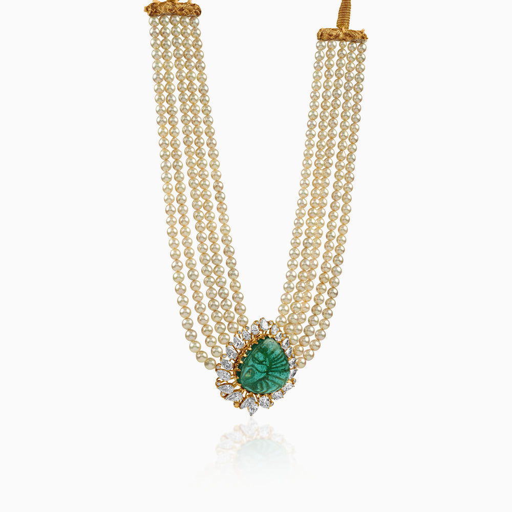 Pearl necklace with emerald pendant surrounded by diamond-studded gold setting