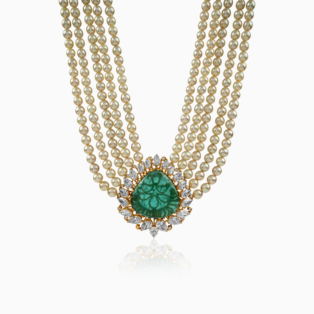 Pearl necklace with emerald pendant, surrounded by diamond-studded gold setting