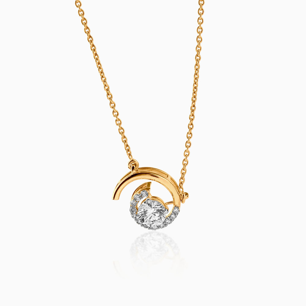Gold necklace with diamond pendant in curved crescent design, suspended on delicate chain