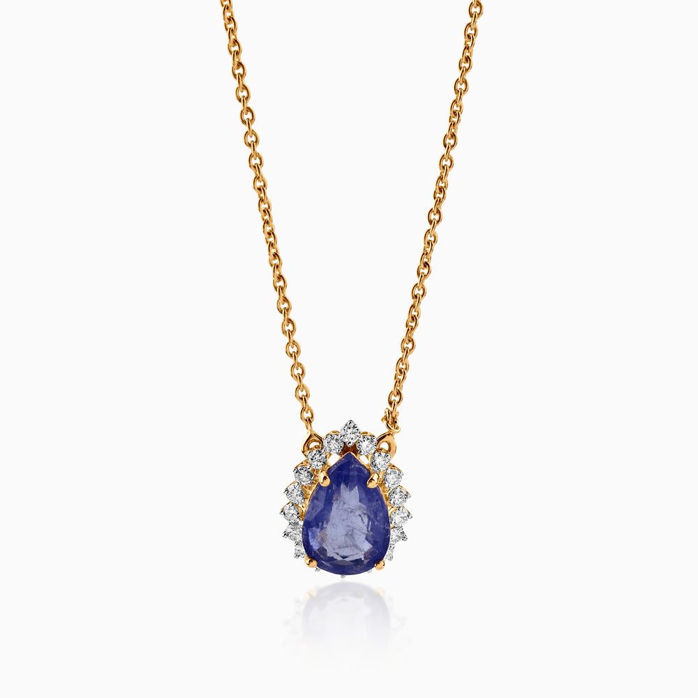 Gold necklace with teardrop sapphire pendant, surrounded by sparkling white diamonds.