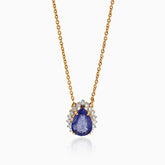 Gold necklace with teardrop sapphire pendant, surrounded by sparkling white diamonds.