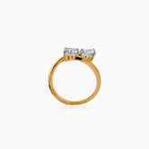 Gold ring with two sparkling white diamond stones in unique asymmetrical setting