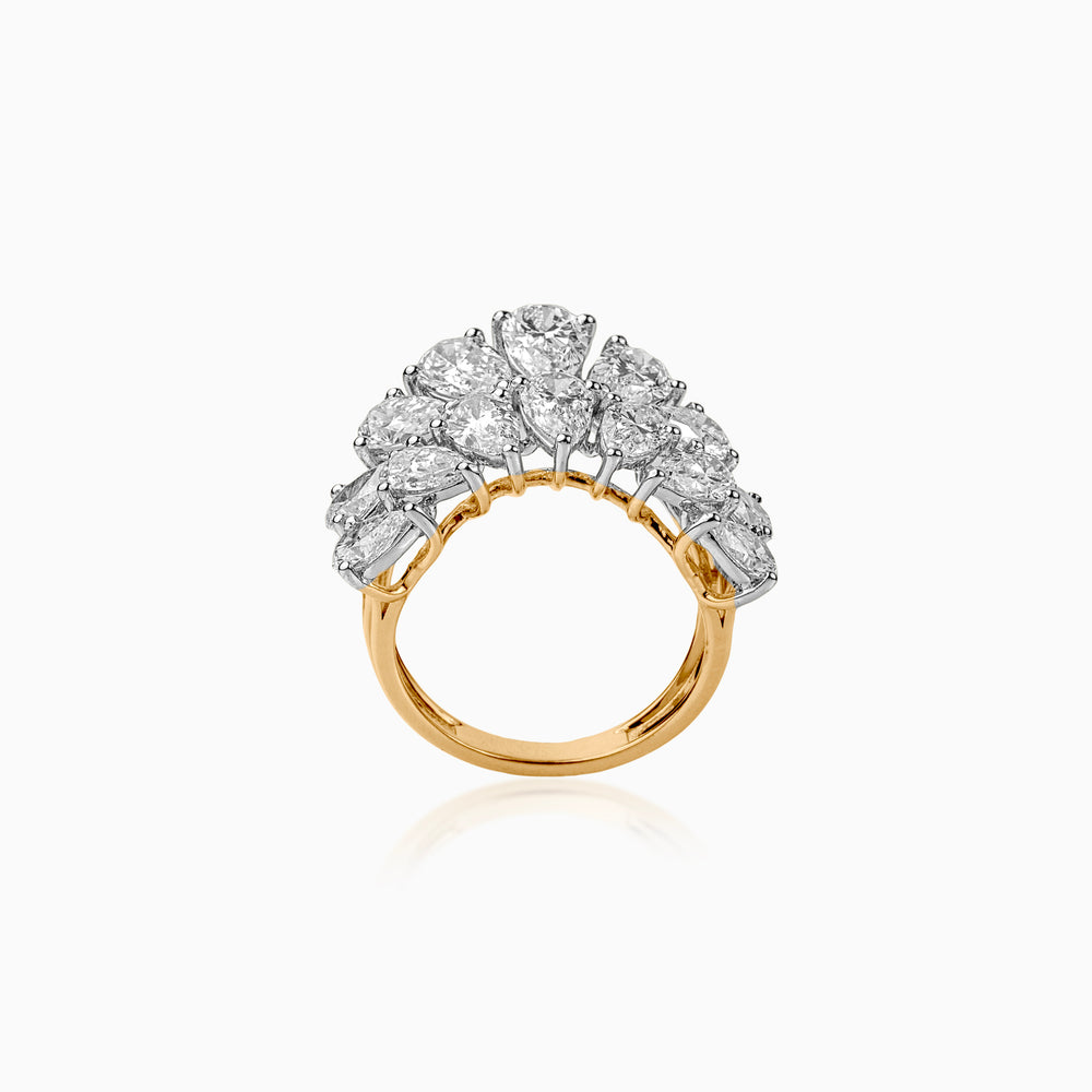 Gold ring with clustered round diamonds in silver prong settings, elegant statement piece.