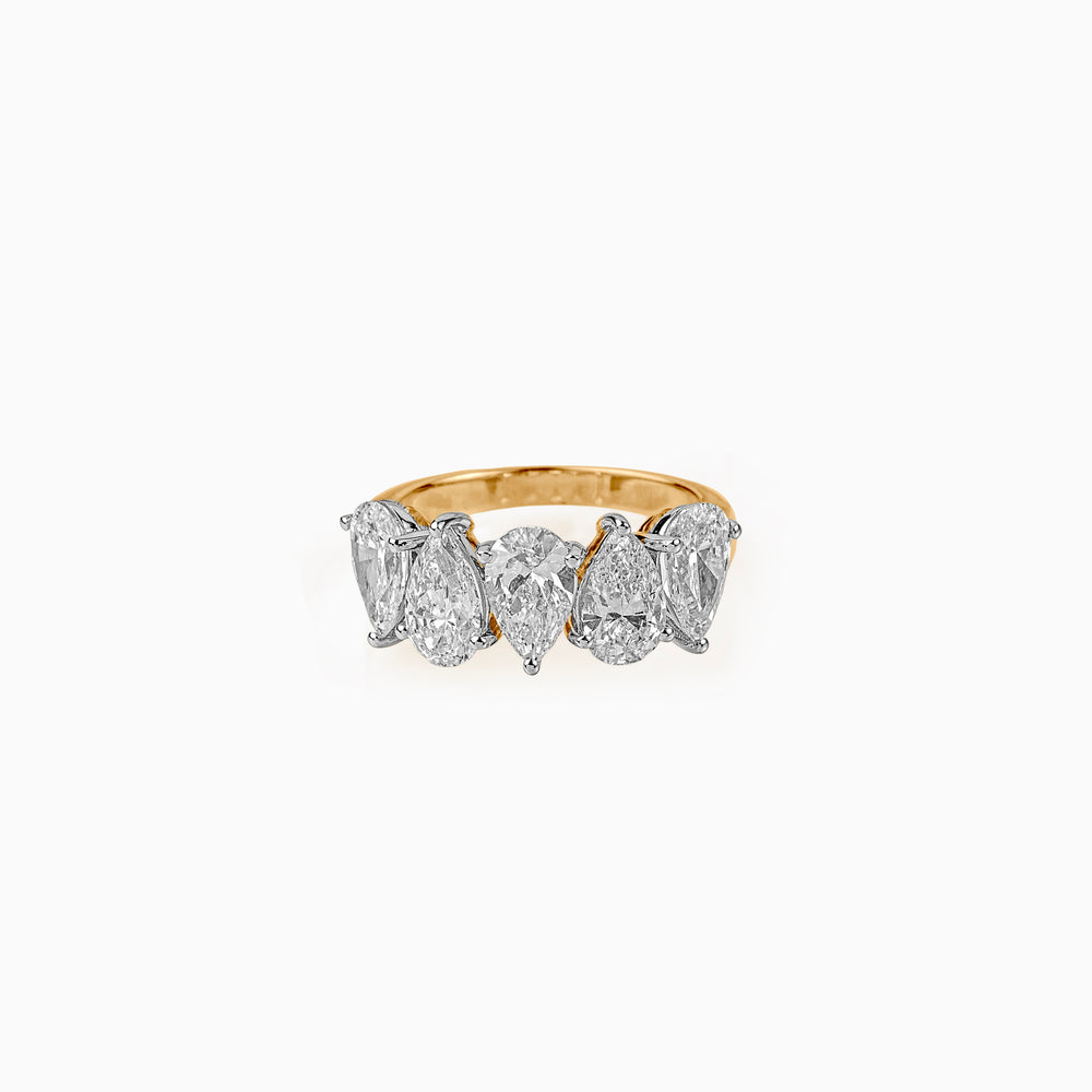 Gold ring with five pear-shaped diamonds in white gold setting against white background
