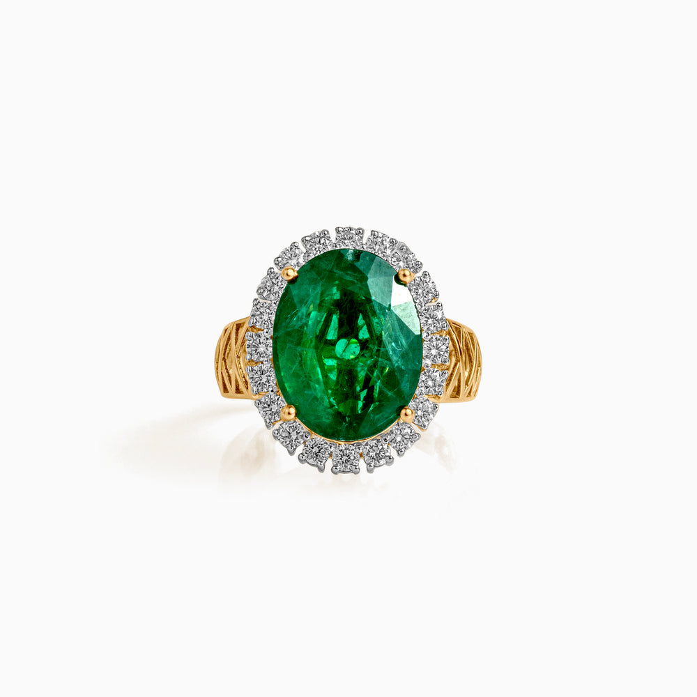 Oval emerald ring with diamond halo on gold twisted band, jewelry close-up shot
