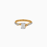 Gold and diamond engagement ring with emerald-cut center stone and twisted pavé band