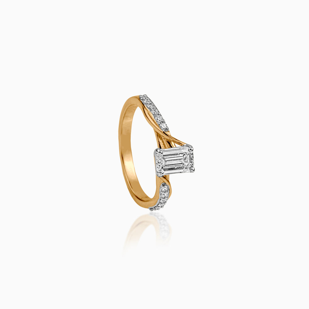 Gold and white gold engagement ring with emerald-cut diamond and diamond-studded band