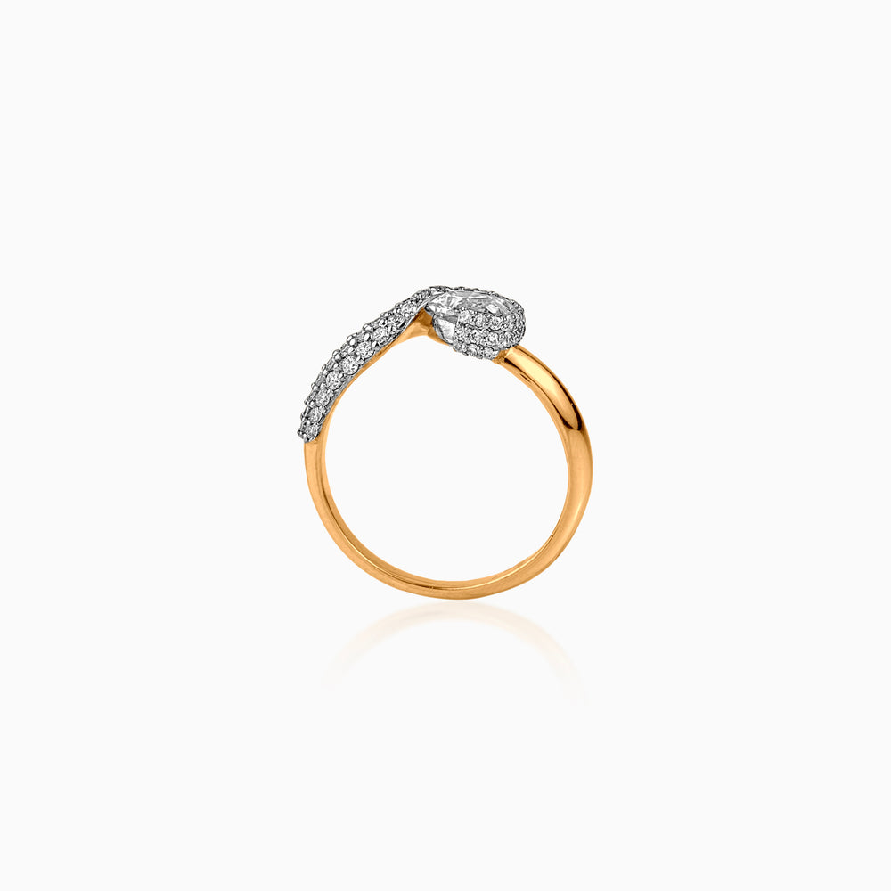 Gold ring with diamond-encrusted curved sections on white background