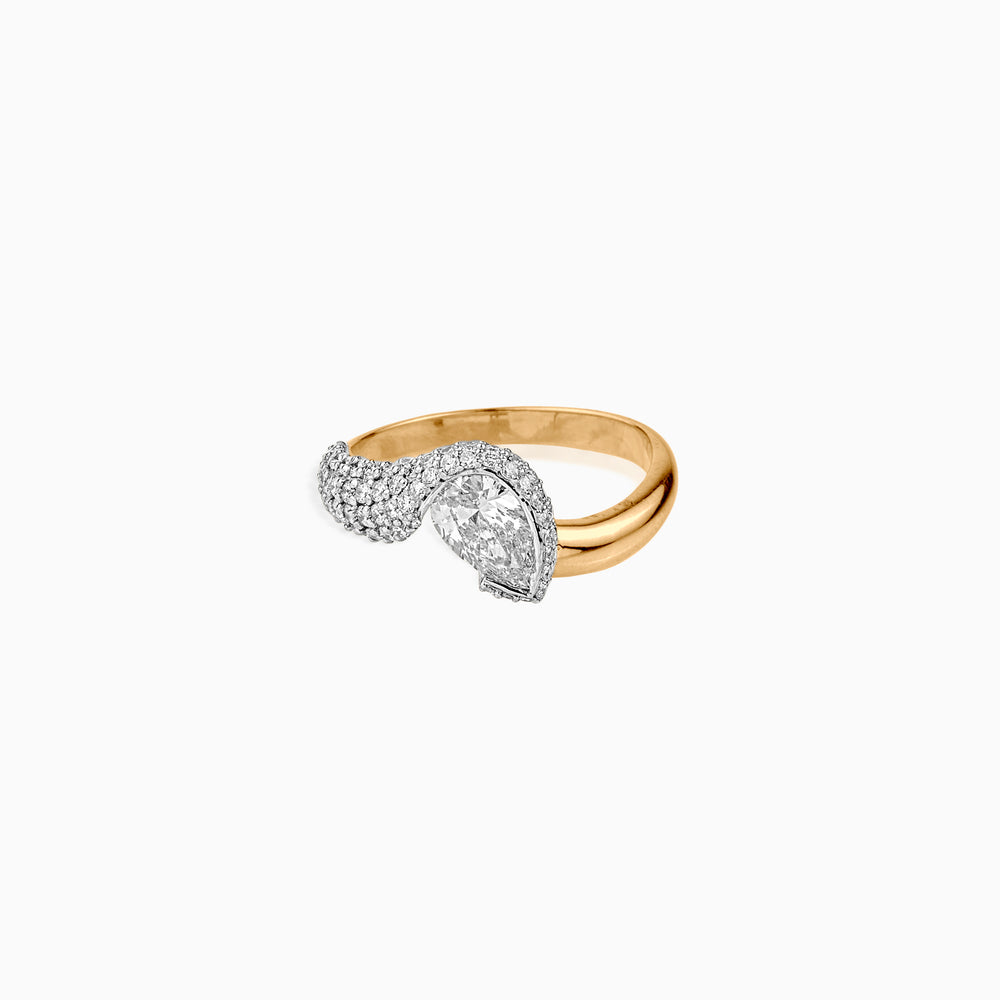 Gold ring with pear-shaped diamond and pavé diamond accent in white gold setting