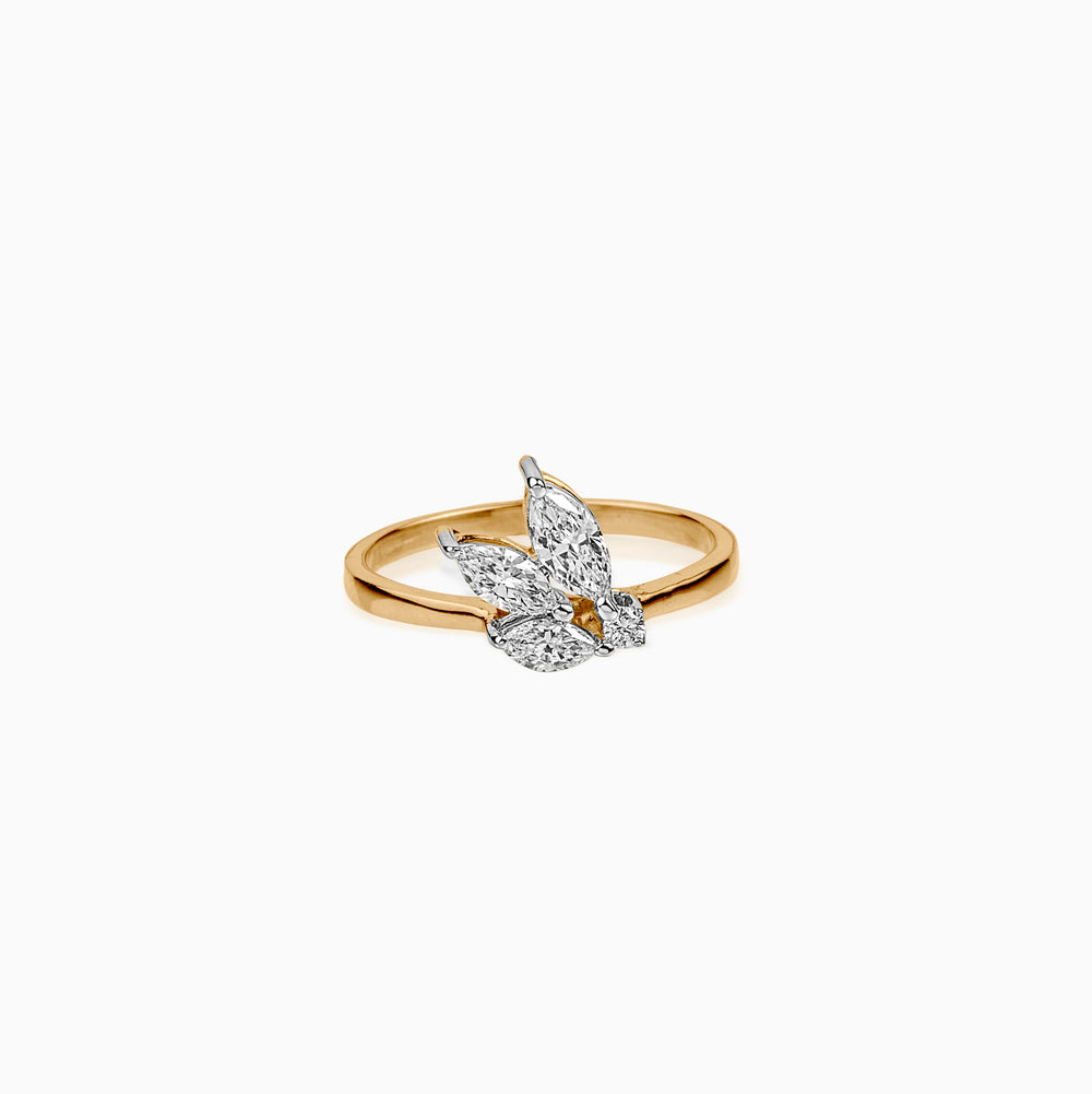 Gold ring with butterfly-shaped diamond cluster on white background