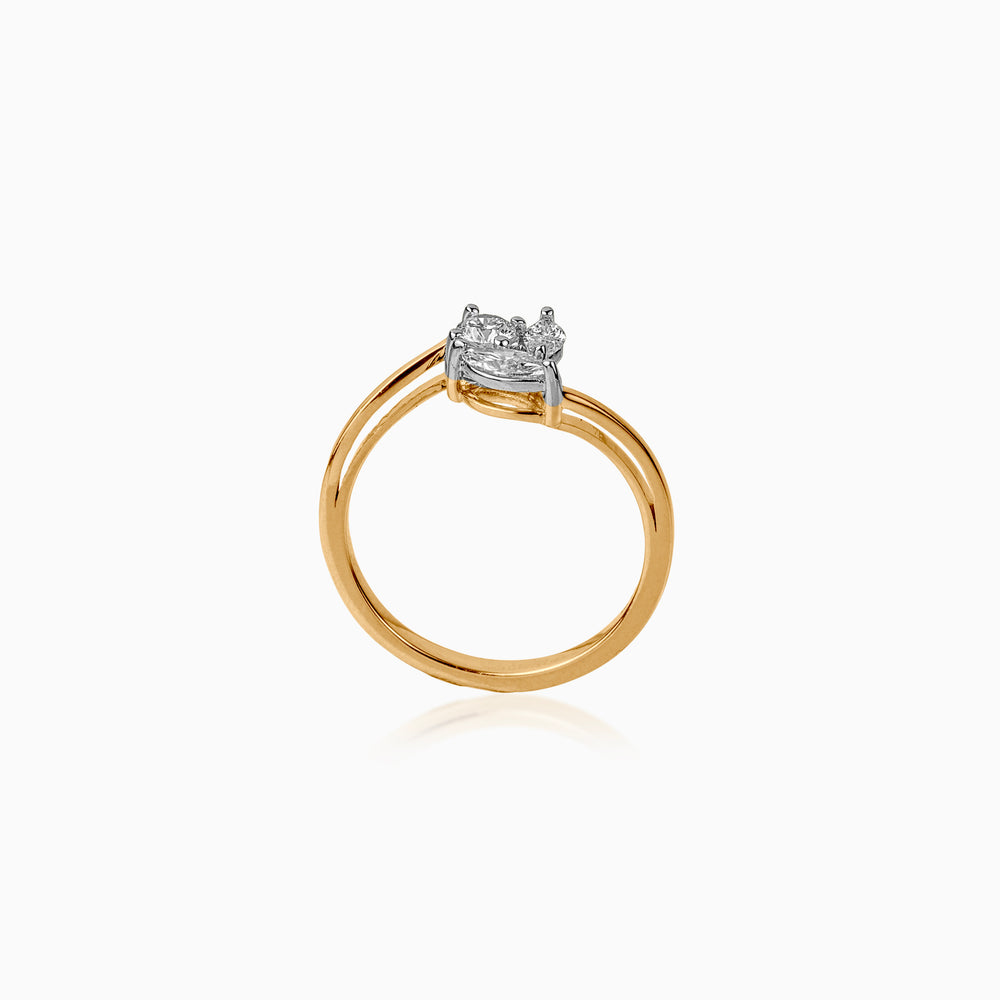 Gold ring with diamond cluster in white gold setting, delicately positioned on white background